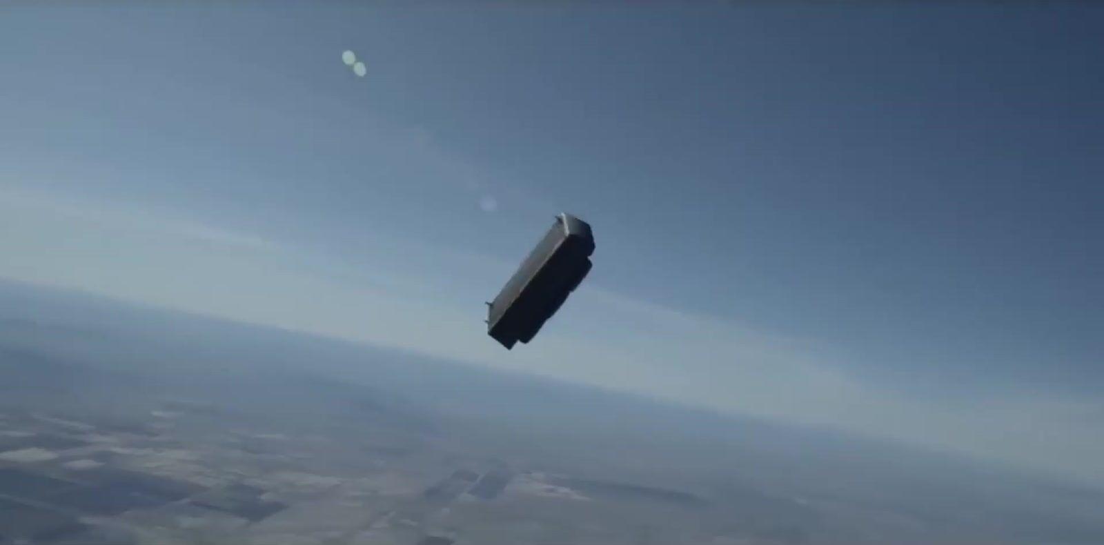 a small airplane flying through a blue sky
