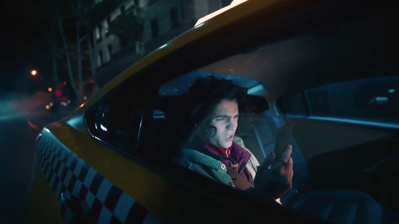 a woman sitting in a taxi looking at her cell phone