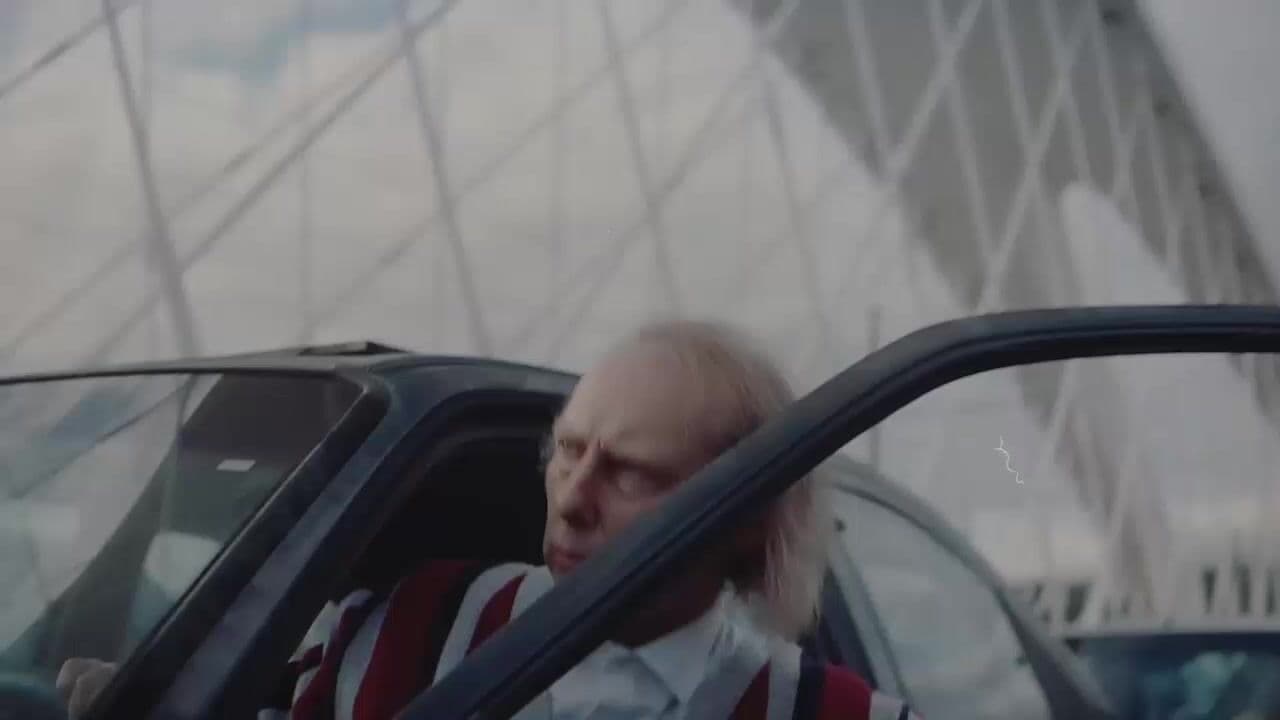 a man with long hair sitting in a car
