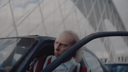 a man with long hair sitting in a car