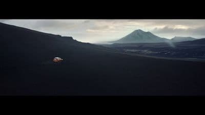 a person riding a motorcycle on top of a hill