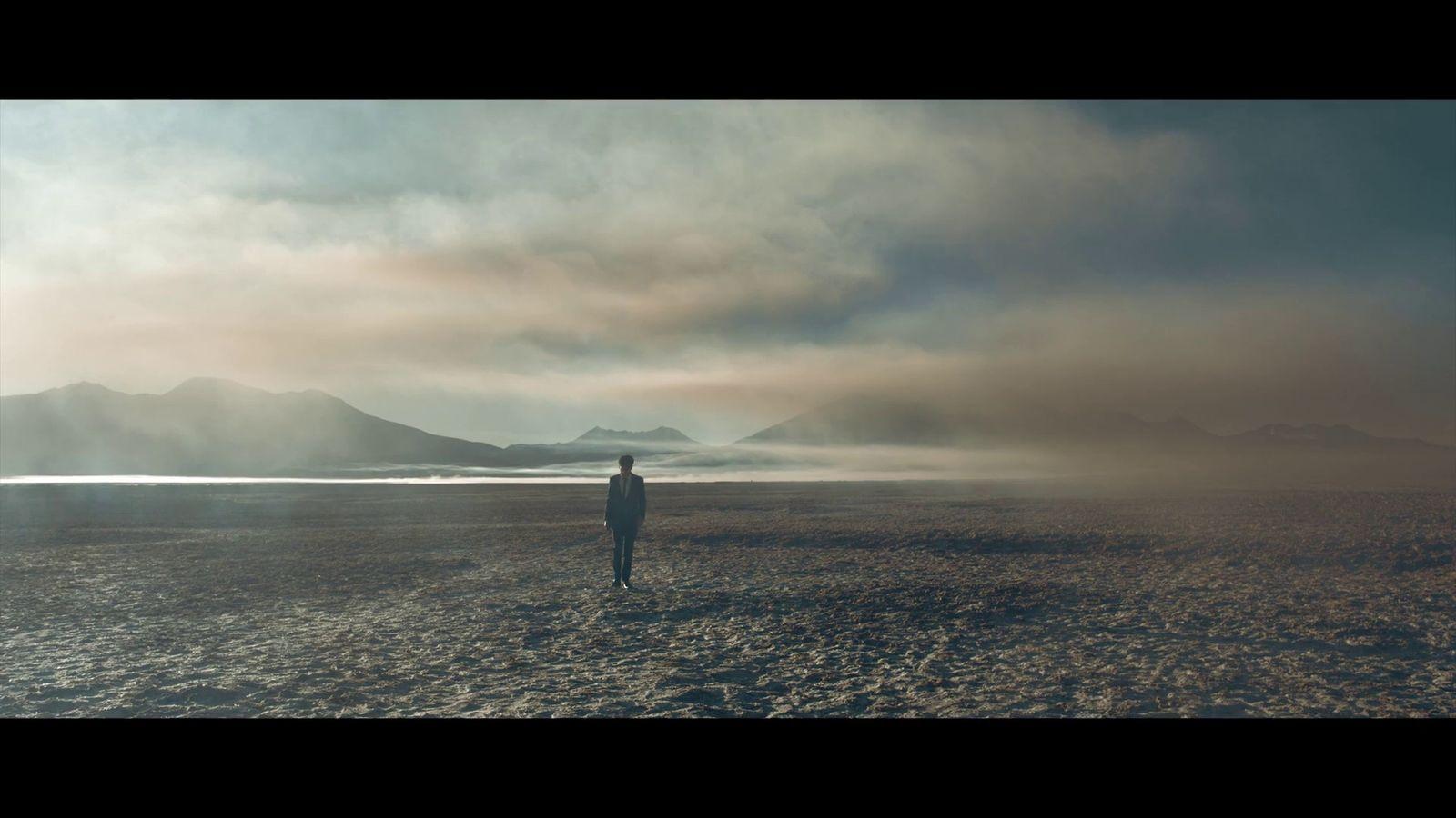 a person standing in the middle of a desert