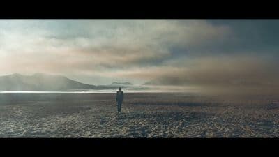 a person standing in the middle of a desert