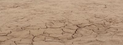a close up of a dirt field with little cracks