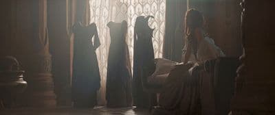 a group of women standing in a room next to a window