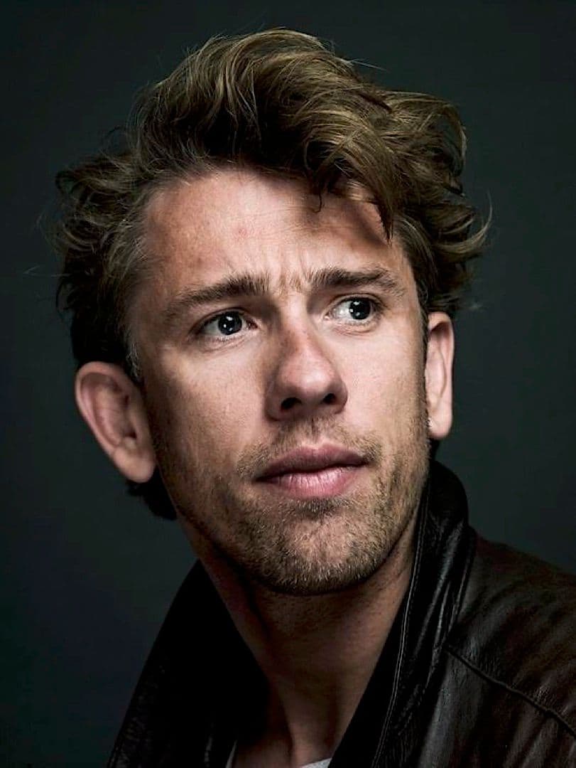 a close up of a person wearing a leather jacket