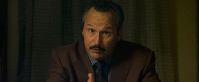 a man in a suit and tie making a face