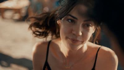 a close up of a person wearing a tank top