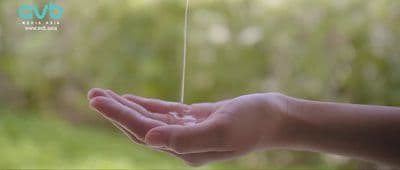 a person holding out their hand with a string attached to it