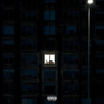 a man standing in a window of a tall building