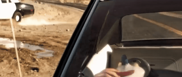 a person driving a car on a dirt road