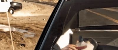 a person driving a car on a dirt road