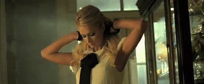 a woman in a white shirt and black tie