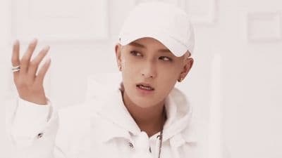 a male in a white jacket and a white hat