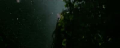 a person standing in the rain with an umbrella