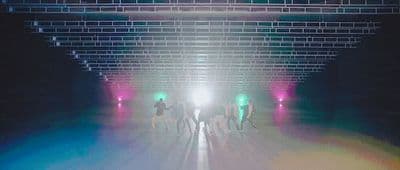 a group of people walking through a tunnel