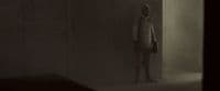 a person standing in a room with a light on