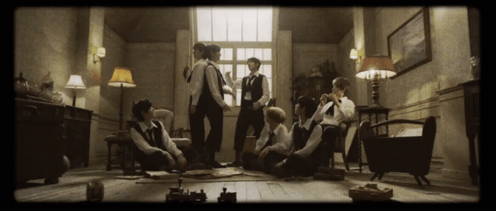 a group of young men standing around a living room