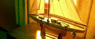 a toy sailboat sitting on top of a wooden table
