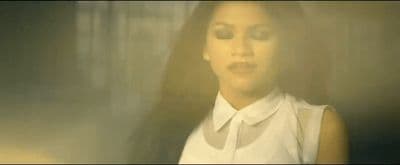 a woman wearing a white shirt and tie