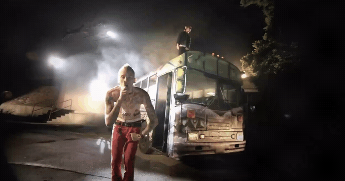 a man standing in front of a bus at night