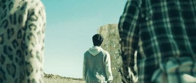 a man standing in the middle of a desert