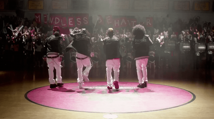 a group of men standing on top of a basketball court