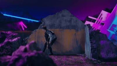 a man standing in front of a wall with neon lights