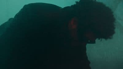 a man with his head down in a dark room