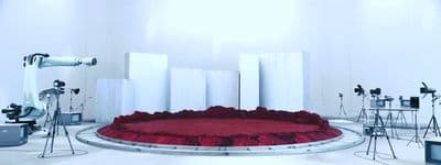 a stage with a red carpet surrounded by white walls