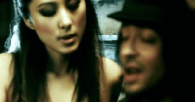 a man and a woman looking at a cell phone