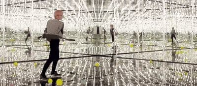 a man standing in front of a large mirror