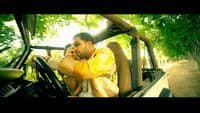 a man sitting in a car talking on a cell phone