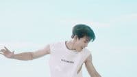 a man in a white shirt is holding his arms out