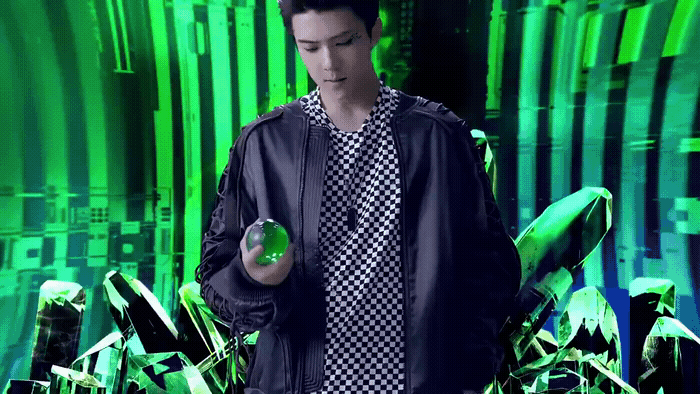 a man standing in front of a green background