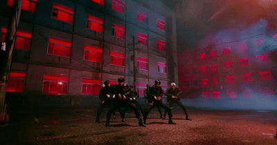 a group of people standing in front of a building