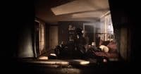 a person standing in a dark room with a couch