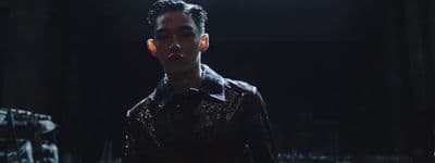 a man in a dark room with a pair of ear phones in his ears