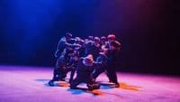 a group of people standing on top of a stage