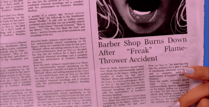 a person holding up a newspaper with a picture of a woman's mouth