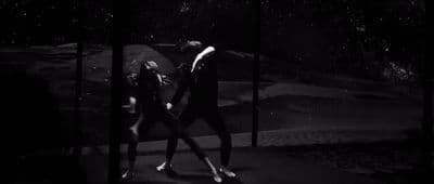 a couple of people that are standing in the dark