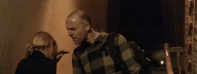 a man standing next to a woman in a room