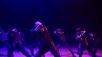 a group of people dancing on a stage