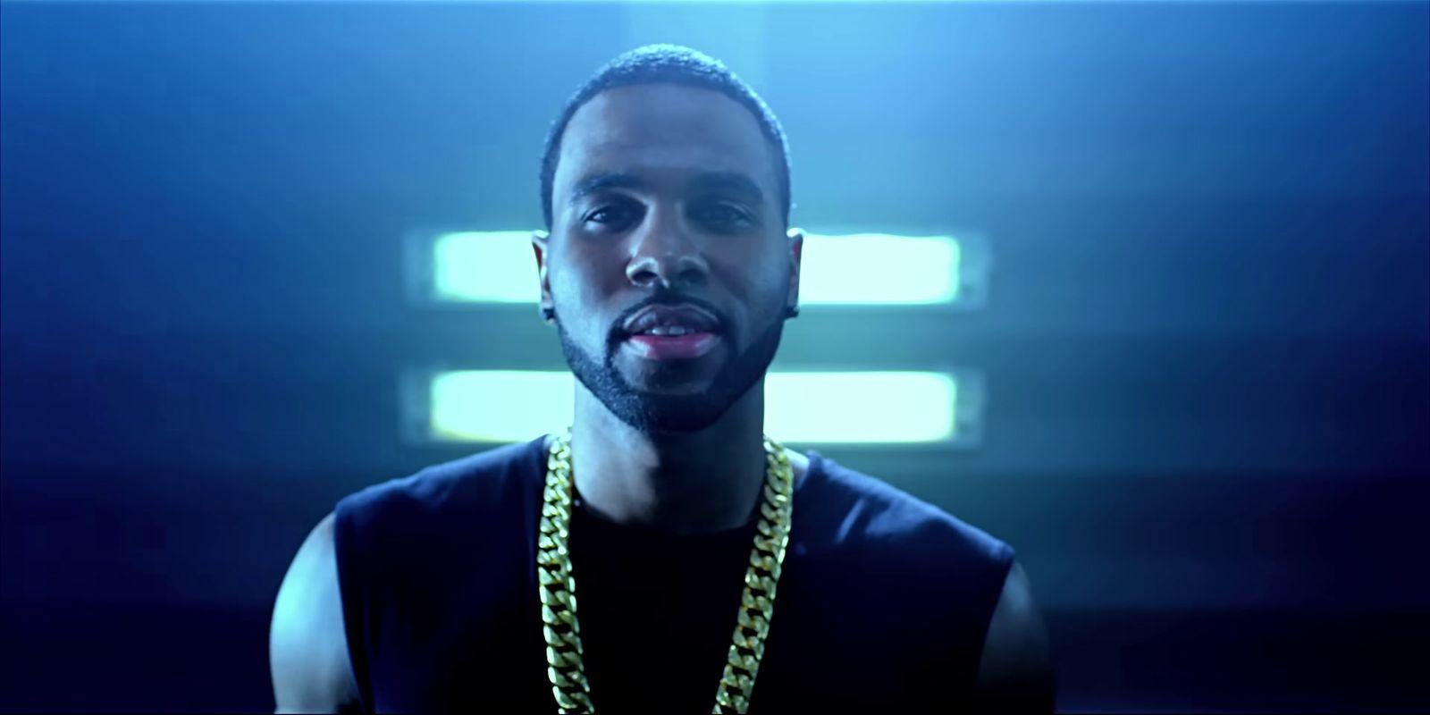 a man wearing a black shirt and a yellow chain