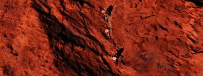 a group of people climbing up a red mountain