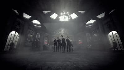 a group of people standing in a dark room