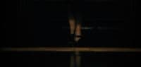 a woman's feet in high heels in the dark