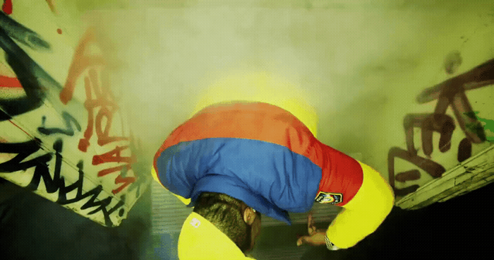 a man in a blue and yellow jacket is bending over