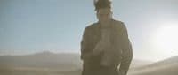 a man standing in the middle of a desert