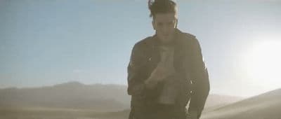a man standing in the middle of a desert